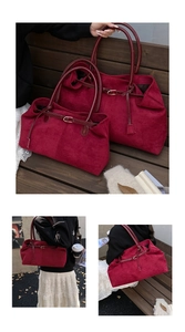 Detail of burgundy suede tote bags in two sizes with glossy leather straps and metal hardware