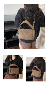 Detail view of dark brown suede shoulder bag with adjustable strap on a model