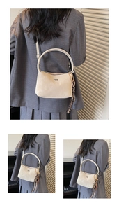 Detail of beige suede bucket bag with round handle and decorative silk scarf