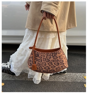 Fashionable leopard print shoulder bag detail with leather straps and suede texture