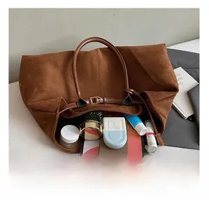 Macro view of the brown matte leather tote bag interior showing large storage capacity
