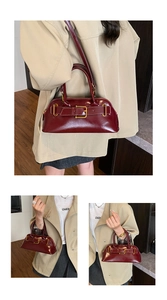 Detail of burgundy shell-shaped leather handbag with gold buckle and adjustable strap