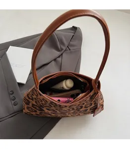 Detailed interior of leopard print shoulder bag showcasing storage space for daily essentials