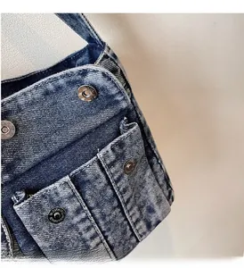 Close-up of heavy washed denim fabric texture with silver metal button detail