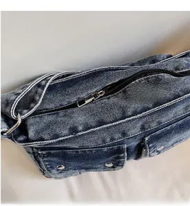 Detail of smooth metal zipper and vintage denim texture on a blue washed tote bag