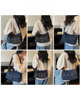 Close-up of washed denim shoulder bag featuring dual front flap pockets and silver studs