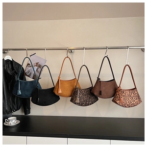 Variety of vintage crescent shoulder bags with leopard print and solid suede finishes