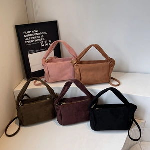 Japanese style nylon shoulder bags in five colors displayed on a white geometric stand