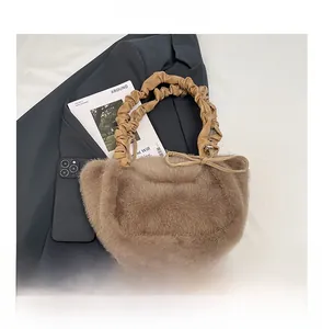 Detail of faux fur tote bag with ruched PU leather handle and decorative ribbon bow