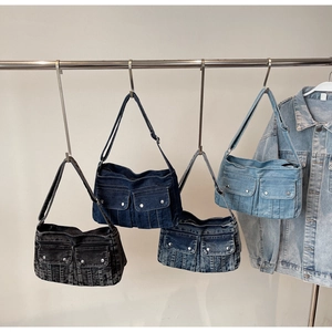 Detail view of denim tote bags in four washes featuring cargo pockets and metal buckles