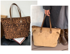 Detail view of large leopard print and camel suede tote bags with drawstring side accents