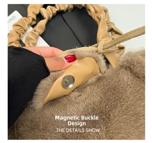 Detail view of the secure silver magnetic clasp on a plush brown faux fur handbag