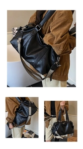 Detail of black large capacity tote bag with stylish geometric woven wide shoulder strap