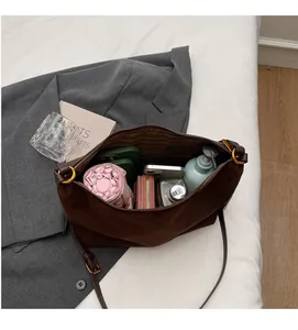 Macro detail of the spacious inner compartment of the brown suede hobo bag