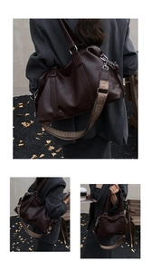 Detail of dark brown tote bag with wide geometric woven strap on a dark blazer