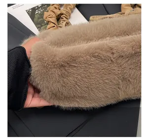 Detail of coffee brown plush tote with fuzzy texture and pleated leather handle