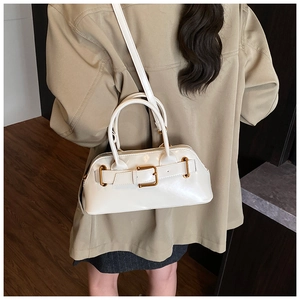 White glossy faux leather Boston bag with decorative buckle and dual handle detail