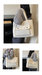 Detail der gesteppten cremefarbenen Tragetasche mit großer Tasche und zwei Knöpfen
