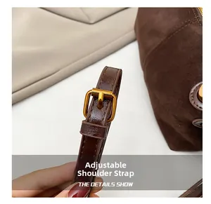 Detail of adjustable brown leather shoulder strap with vintage gold square metal buckle
