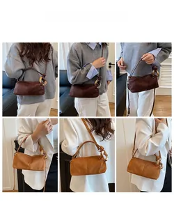 Detail showing vintage suede shoulder bags in dark brown and caramel with gold chain