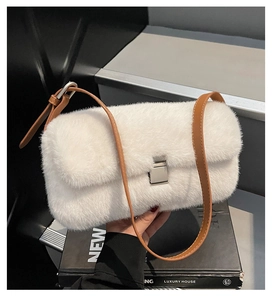 Close-up of white plush shoulder bag featuring silver metal lock and brown leather strap