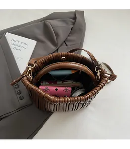 Top view of a brown pleated bucket bag interior showing spacious storage and accessories
