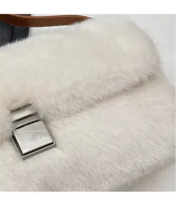 Detailed macro view of white plush fabric texture and square silver metal buckle on handbag