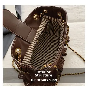 Macro detail of the brown bucket bag internal structure with striped lining and zipper pocket