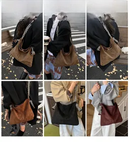 Detail view of suede tote bags in various colors with striped woven shoulder straps