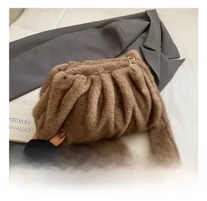 Close-up of the plush brown pleated cloud bag with soft faux fur texture and gold hardware