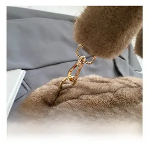 Detail of high-quality gold metal clasp on brown plush faux fur vintage shoulder bag