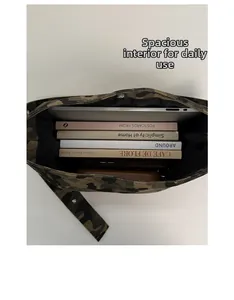 Spacious interior of camo canvas bucket bag showing 14-inch laptop and books capacity