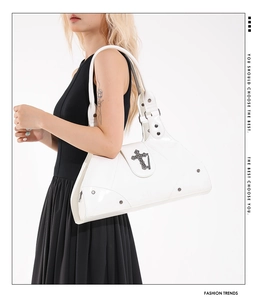 Detail of white oil wax leather tote with gothic metal crosses and punk style rivets
