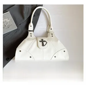 Detail view of white biker style handbag featuring a vintage metal cross and stitch pattern