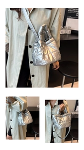 Detail view of silver quilted puff handbag with metallic finish and adjustable strap