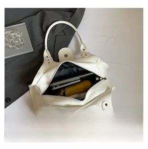 Internal view of white patent leather tote bag showing large capacity for essentials