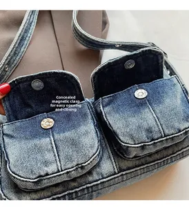 Detail of denim shoulder bag featuring dual front pockets with hidden magnetic closures
