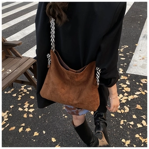 Brown frosted large tote bag with striped woven strap shown in autumn street style