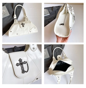 Detail of gothic metal cross buckle and silver chain on vintage white leather tote bag