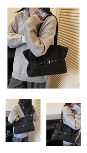 Detail of black suede tote bag featuring adjustable metal belt buckle and matte texture