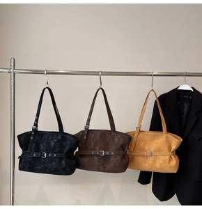 Detailed macro view of large tote bags in three colors with matte textured leather finish