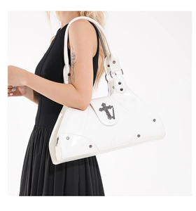 White moto-style tote bag with metal cross relief and decorative rivets on model