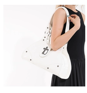 Detail of white punk tote bag featuring glossy leather and gothic silver cross pendant