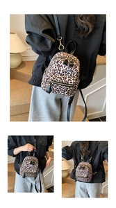 Detail view of mini leopard print backpack with golden zippers and adjustable straps