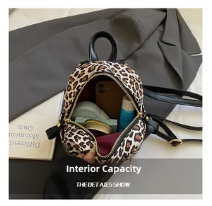 Detail showing the internal storage capacity of the leopard print mini backpack for women