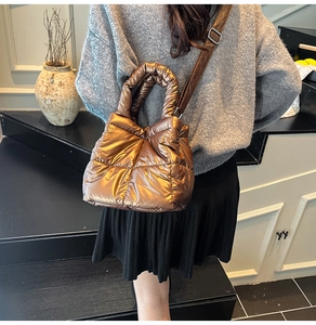 Detail of metallic bronze quilted space cotton bag with adjustable strap and handle