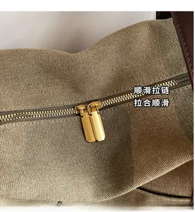 Close-up of durable metal zippers and high-density canvas texture on the tote bag
