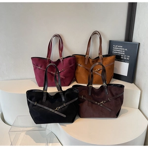 Detail shot of four suede tote bags in burgundy, caramel, black and dark coffee colors