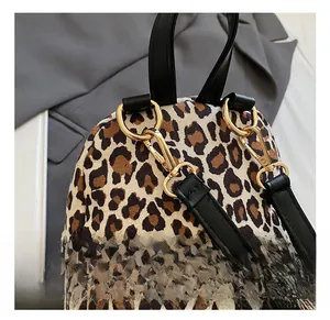 Detail of leopard print backpack with premium gold metal hook and black leather strap