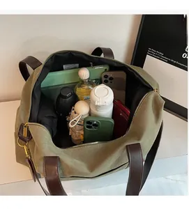 Detailed internal view of large green canvas tote bag showing spacious storage for daily items